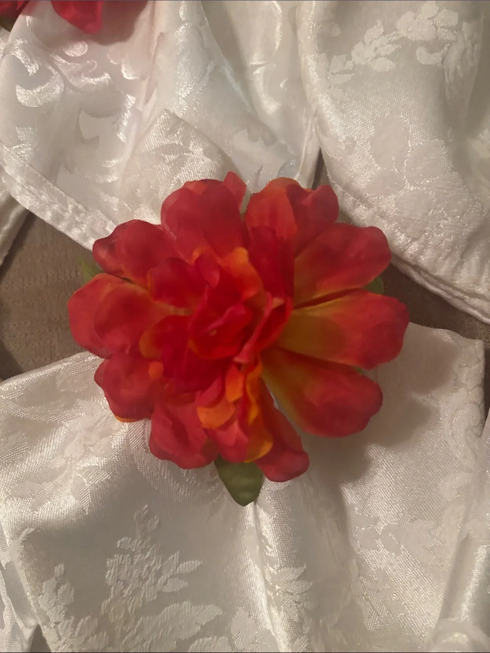 Six large easy care white napkins and 6  floral napkin rings.
